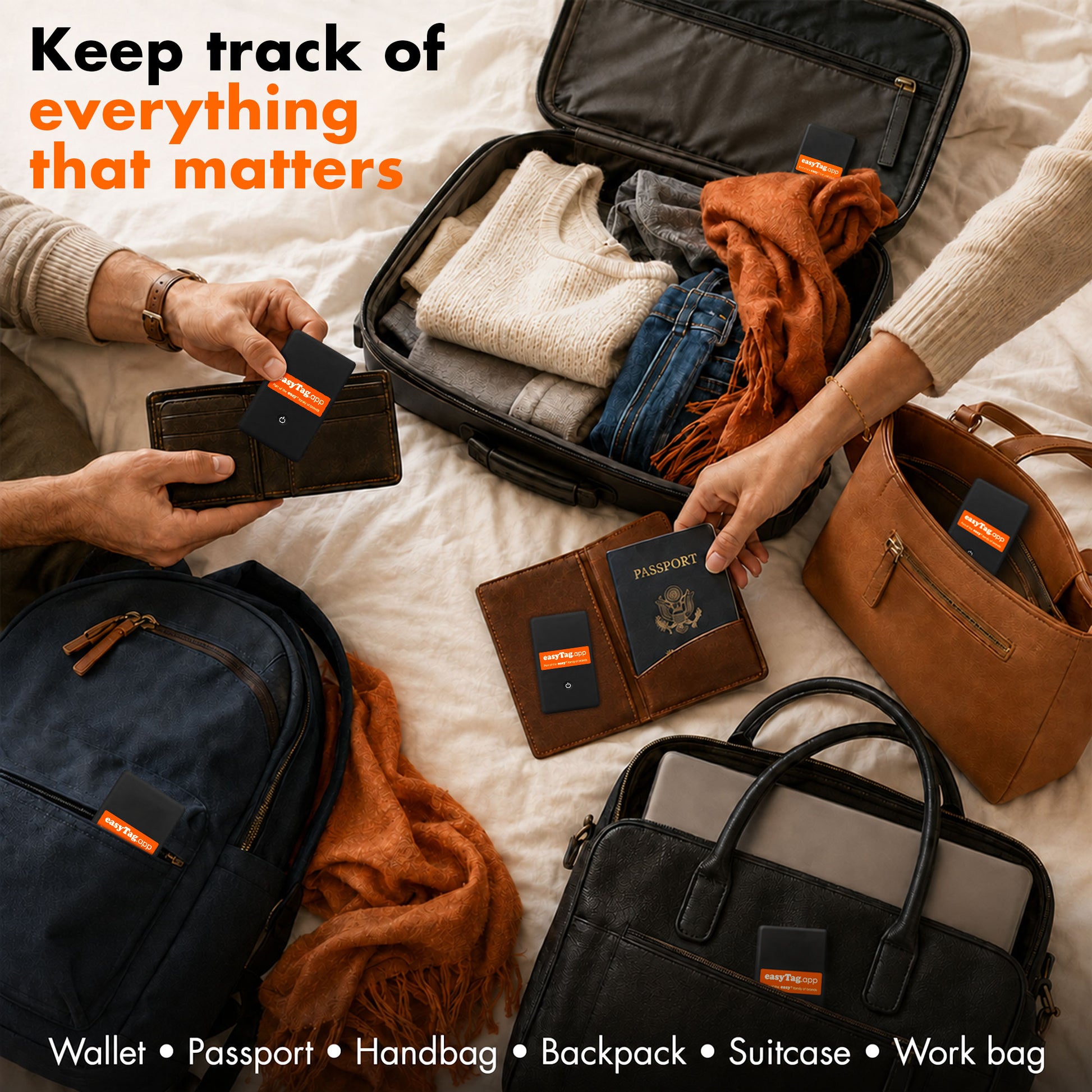 A lifestyle flat-lay showing multiple travel accessories on a bed: an open suitcase with folded clothes and a scarf, a navy backpack, a brown leather work bag, a black tote bag, a brown wallet, a passport, and several small black and orange cardholder-style accessories. Hands are visible placing or holding the items, and text at the top reads 'Keep track of everything that matters' with a bottom caption listing product types.